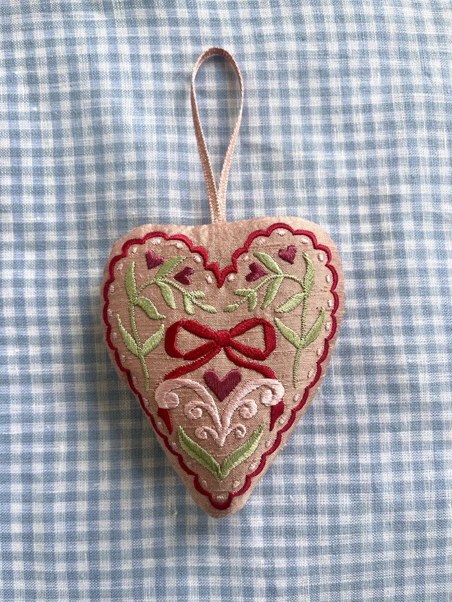 Silk ornament with hand-guided embroidery (pale pink silk with red, green, purple and pale pink embroidery) filled with a mixture of stuffing and dried lavender