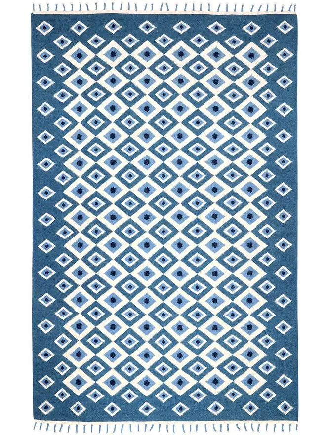 Evil Eye Flatweave Rug, a colourful rug on a plain surface. 