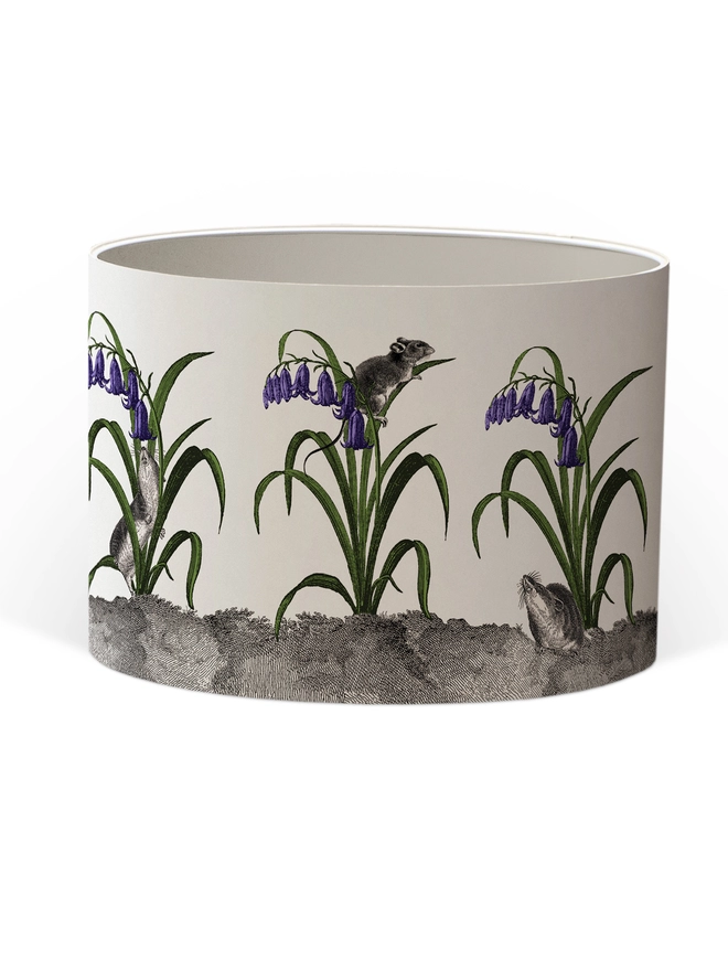 A whimsical lampshade featuring adorable mice hiding among bluebells, creating a charming woodland-inspired design.