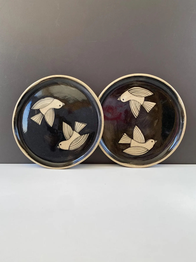 Swallow decorative ceramic plate. A ceramic plate with a bird illustration