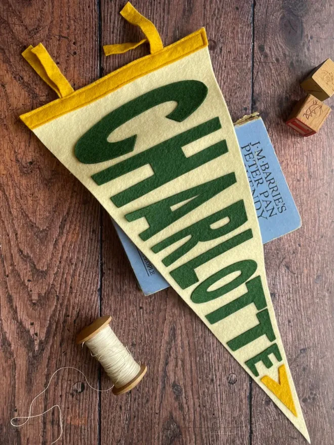 A personalised pennant in cream, green and mustard