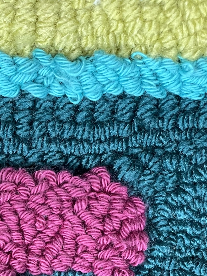 lime, cyan, blue and purple loops of wool forming abstract shapes