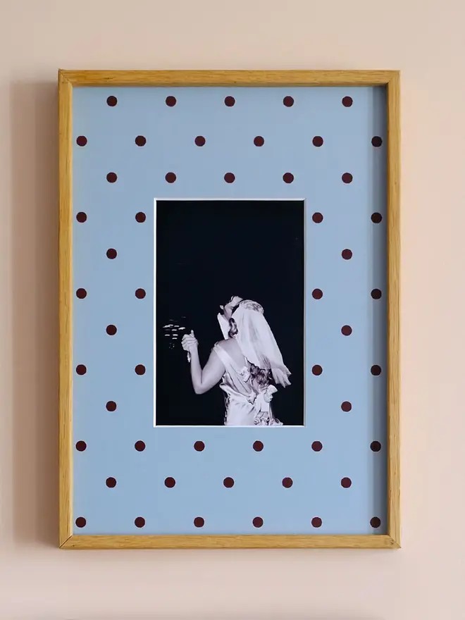 polka dot photo mount. a blue polka dot mount in a frame with a wedding photo in the centre.