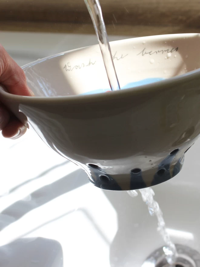 berry bowl in use in kitchen sink