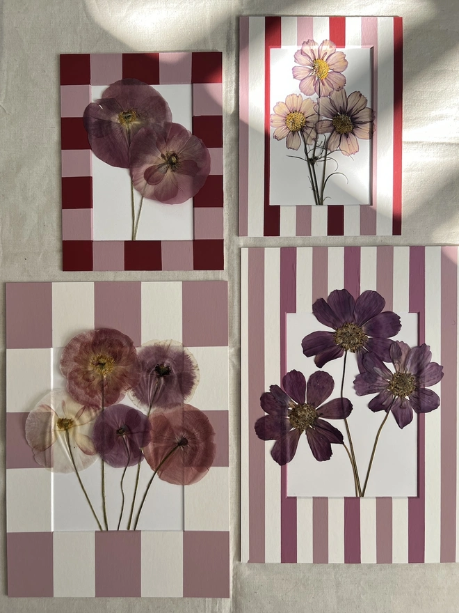 four mounts with pressed flower arrangements