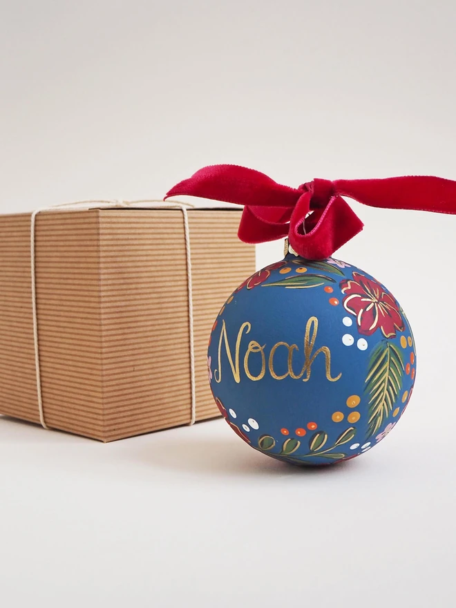 Blue bauble with red flowers and gold personalisation