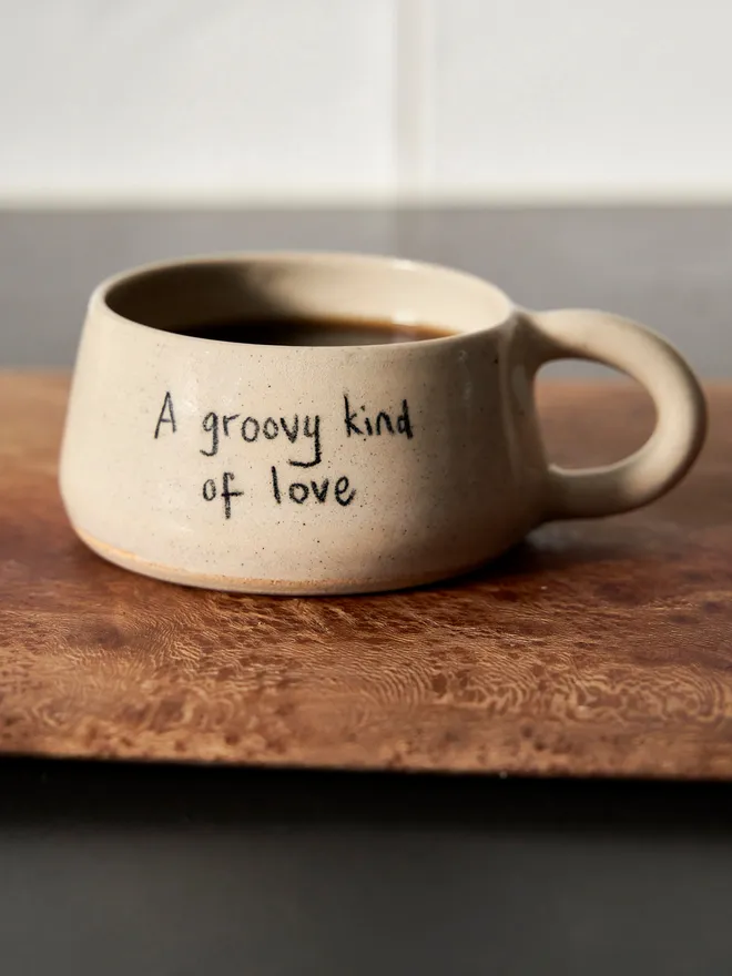 Cream ceramic mug with the words 'A Groovy Kind of Love' written on it 