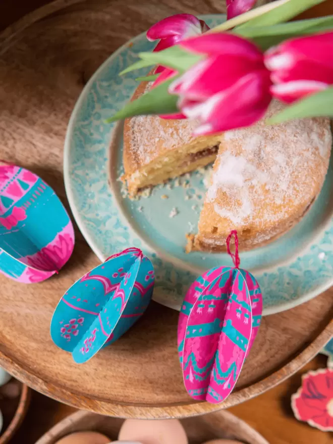 Close-up, detailed shot: pink and blue easter egg sitting on table 