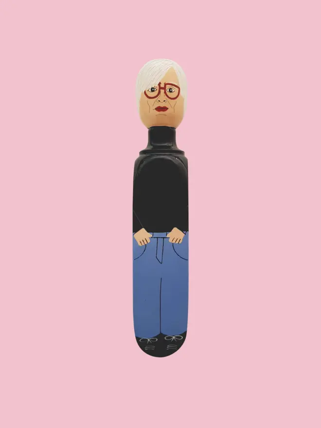 Wooden Door Stopper (Andi), a colourful wooden door stop sitting on a white surface. 