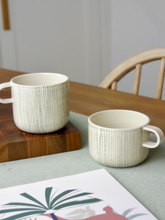 Large and small handmade striped mugs