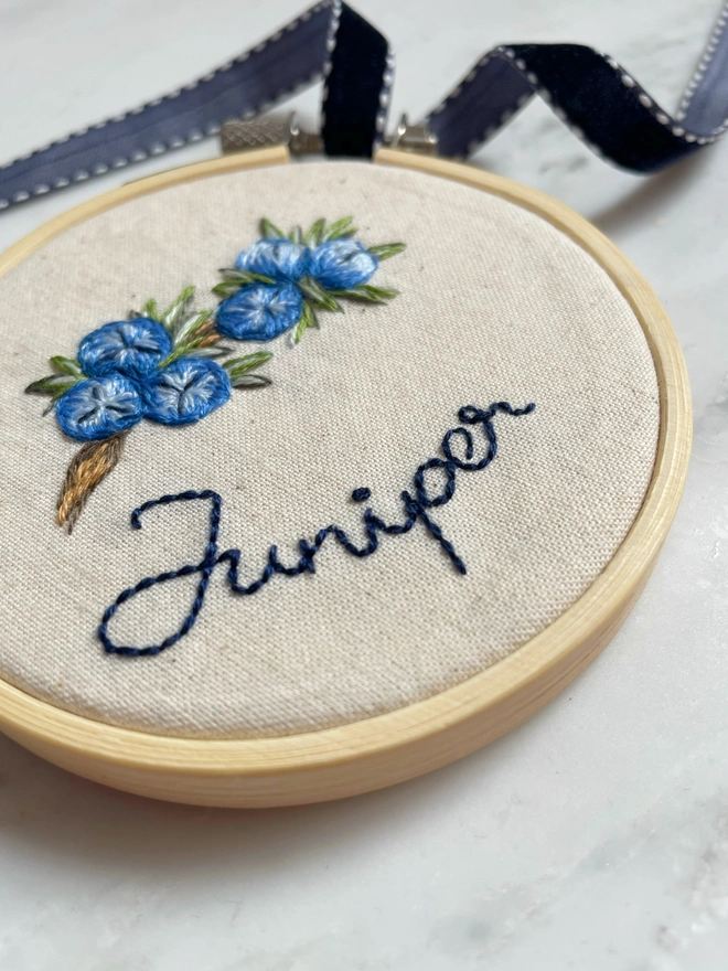 Memorial keepsake with juniper berries and the name ‘Juniper’ 