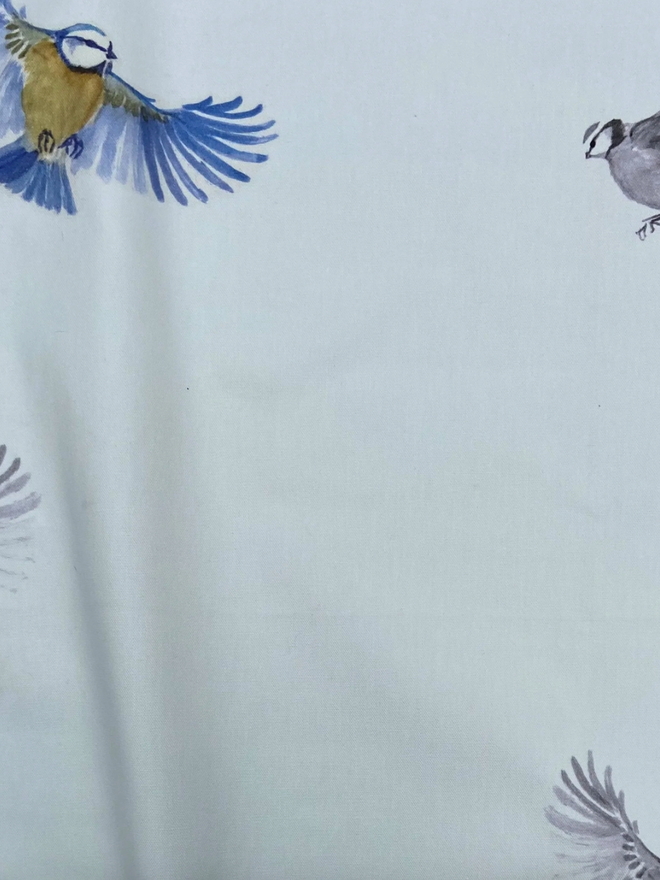 Bird Tablecloth. A white tablecloth patterned with birds.