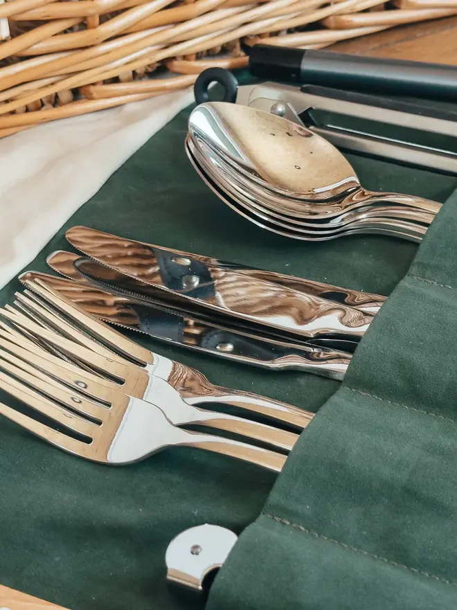 willow complete picnic hamper. stainless steel picnic cutlery in a green cloth holder.