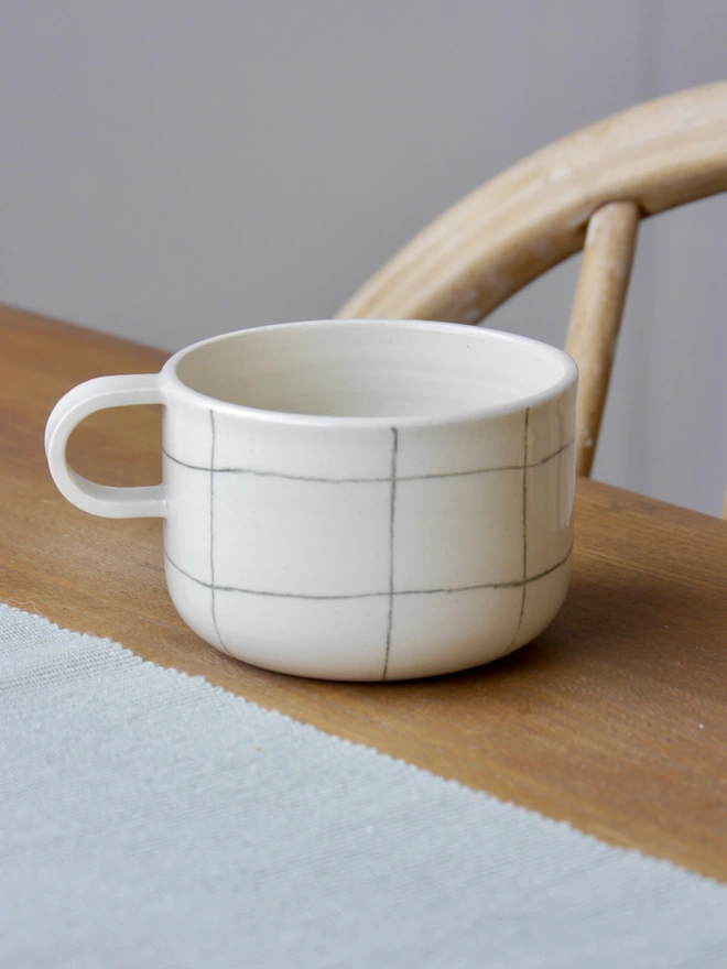 Small handmade grid pattern mug