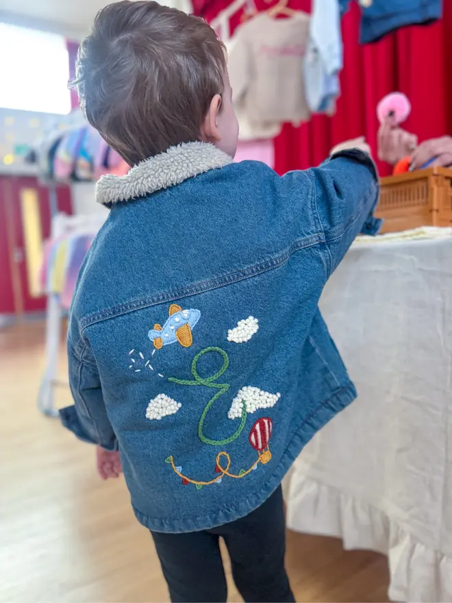 Boy wearing hand-embroidered denim jacket