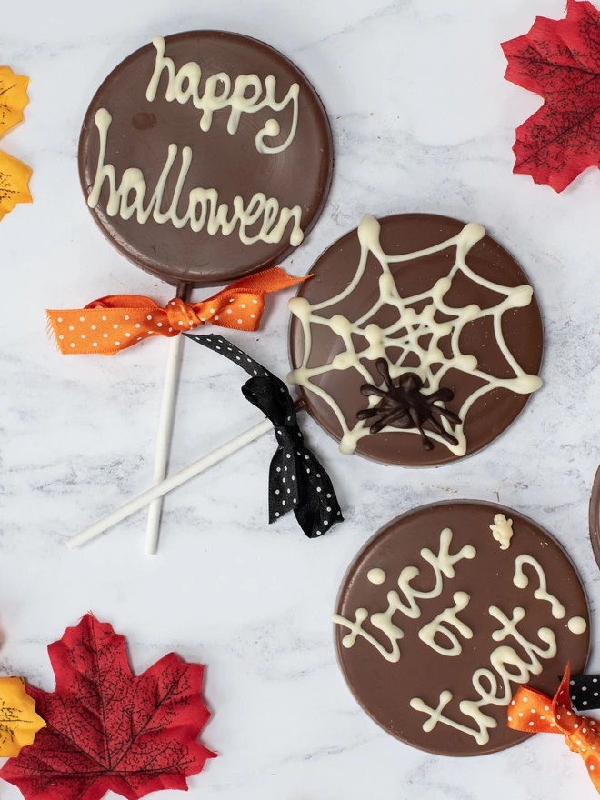 Happy Halloween, spiderweb and trick or treat chocolate lollipops