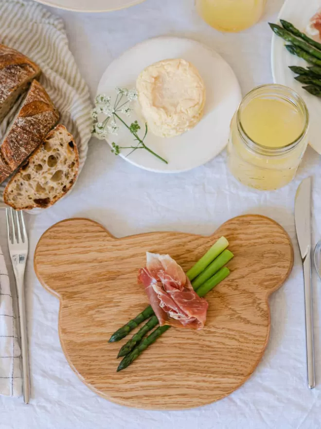 Wooden Bear Serving Board birds eye view with ham and asparagus on the board