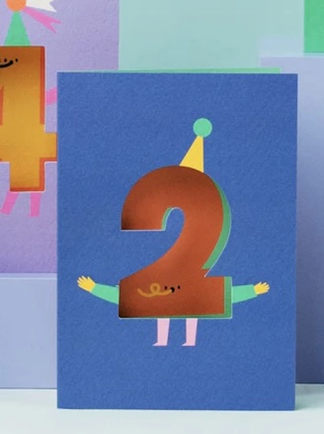 2nd Birthday Card, against a blue background, surrounded by other birthday cards. 