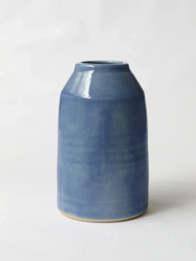 Classic Bud Vase, a colourful ceramic vase sitting on a plain surface against a white backdrop. 