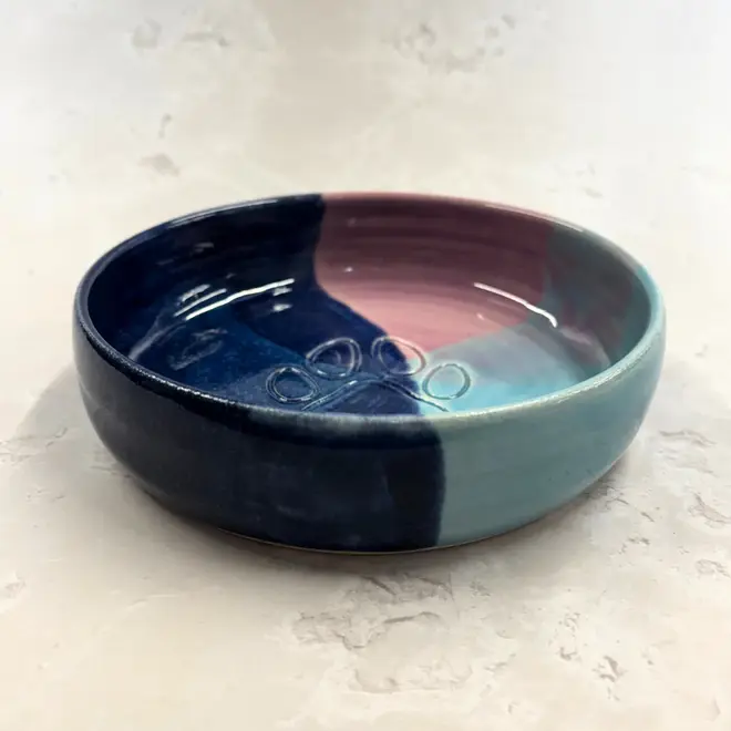 Landscape Dog Bowl, a colourful dog bowl sitting on a stone surface. 