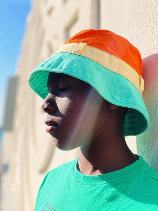 Boy wearing sun bucket hat in multi colour