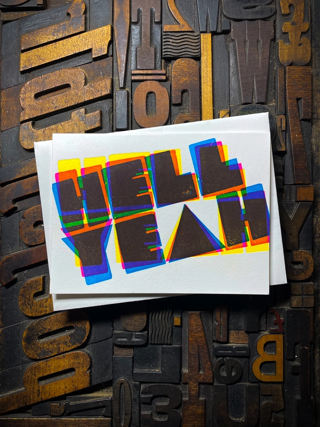 A congratulatory letterpress card using vibrant fluorescent inks the deep impression word HELL YEAH; in bold letters with a set of colourful envelopes. Perfect for exam results and graduations and other celebrations and milestones.