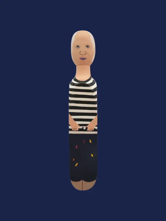 Wooden Door Stopper (Pabs), a colourful wooden door stop sitting on a blue surface. 