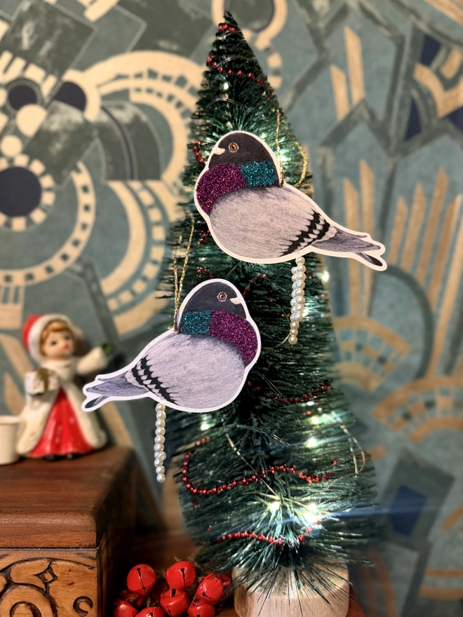 Pooping pigeon decorations with faux pearls and eco glitter on a miniature Christmas Tree