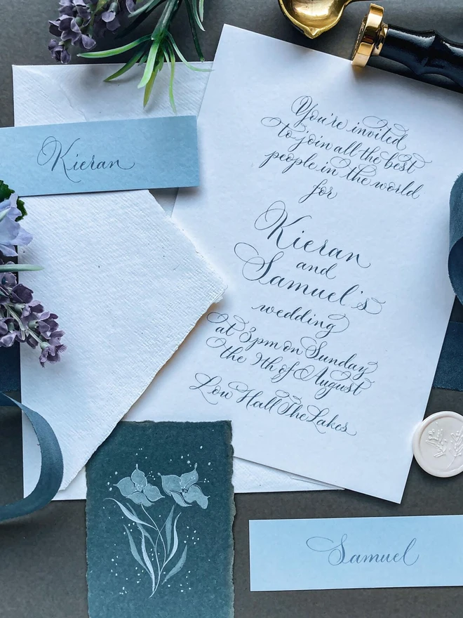bespoke calligraphy wedding invitations. white paper invitations with black calligraphy.