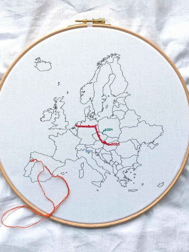 Fabric with Europe printed on it, in a wooden embroidery hoop