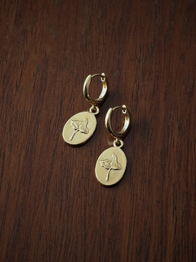 Gold Vermeil Sterling Silver Huggie drop earring with Ivy charms on a dark background showing the opening clasp