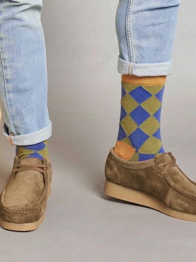 Men's Organic Cotton Ankle Socks Packs (Sets Of 3), a man wearing a pair of colourful patterned socks. 