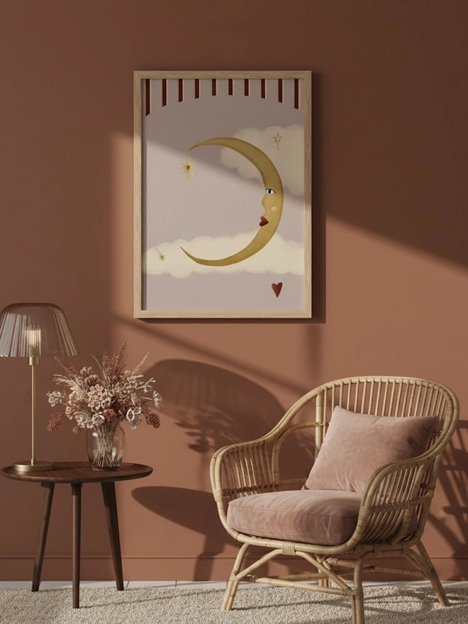 La Lune d'Amour Art Print, a moon print hanging on a coloured wall. 