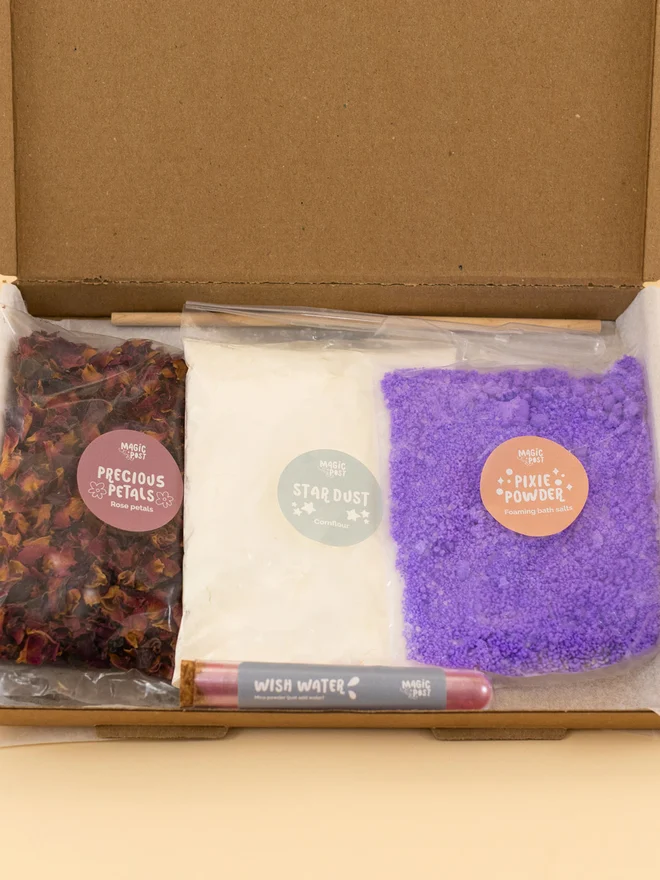 fairy mini potion kit. three bags of various sensory materials placed into a cardboard box.