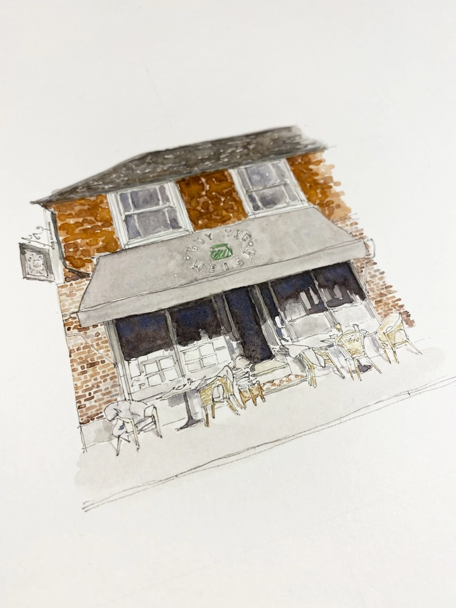 Watercolour painting of Buy the Weigh, zero waste shop in Ticehurst, a beautiful brick building with a teracotta tile on the first floor, white sash windows and a grey awning. The watercolour style is painted with a black pen outline and organic loose style with small details. A photo taken at an angle showing some of the detail. 