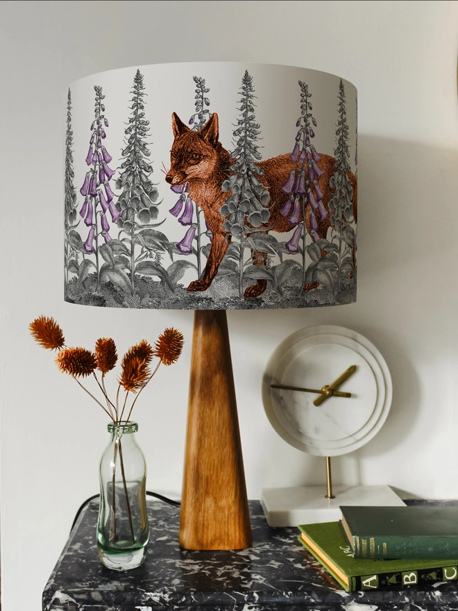 Handmade lampshade featuring a mischievous fox moving through foxglove flowers in a whimsical woodland design.
