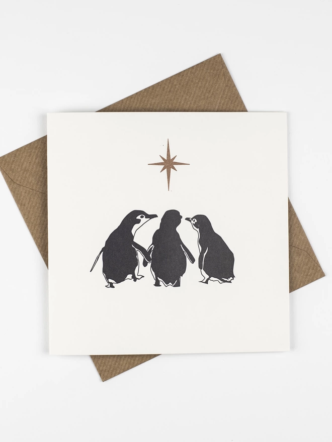 Front of the card three wise penguins