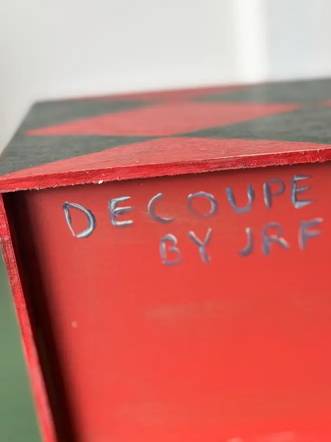 hand-painted harlequin tissue box. a tissue box in red and green signed on the bottom.