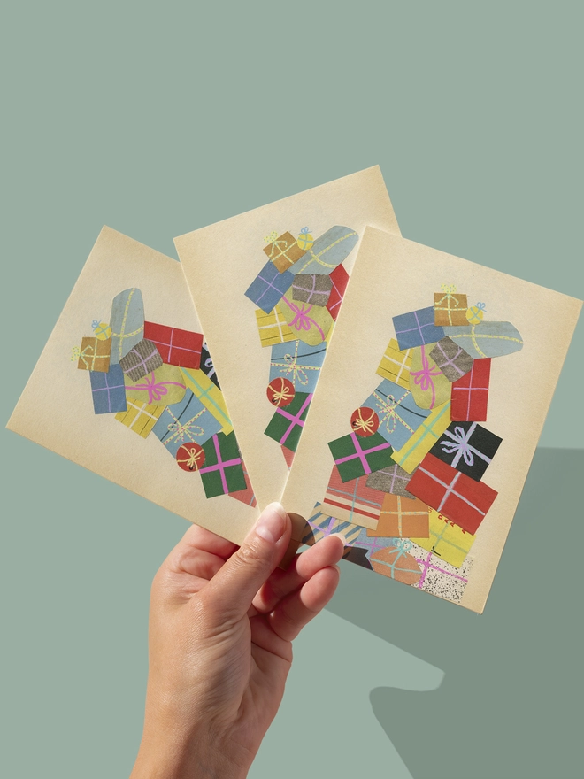 A charming Christmas card featuring a huge pile of colourful wrapped presents.