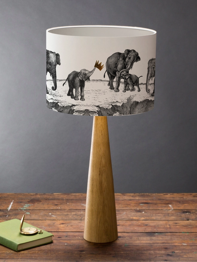 Handmade lampshade featuring adorable mischievous baby elephants playing together, inspired by Whipsnade Zoo, with a playful animal design.
