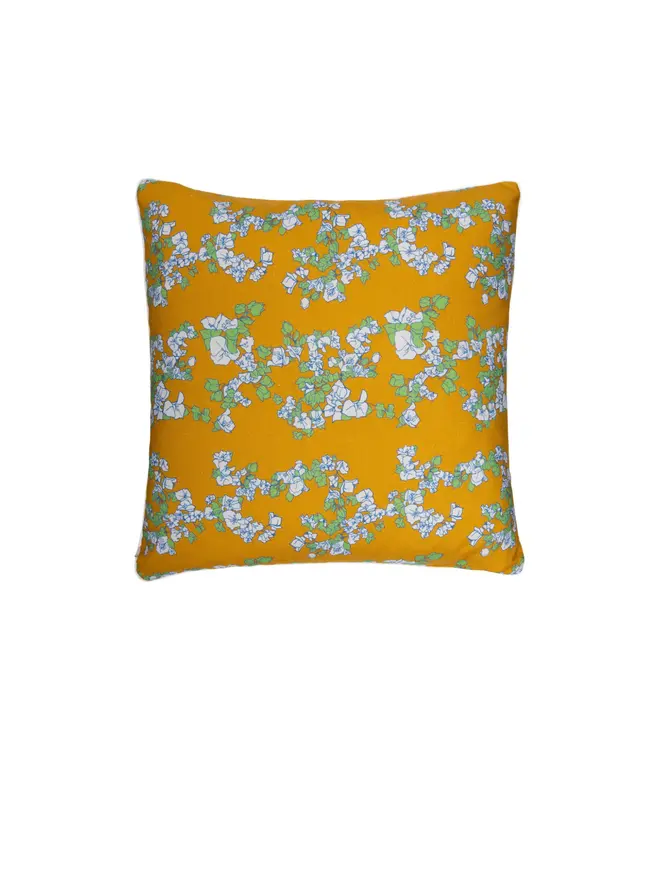 yellow floral cushion on blank background