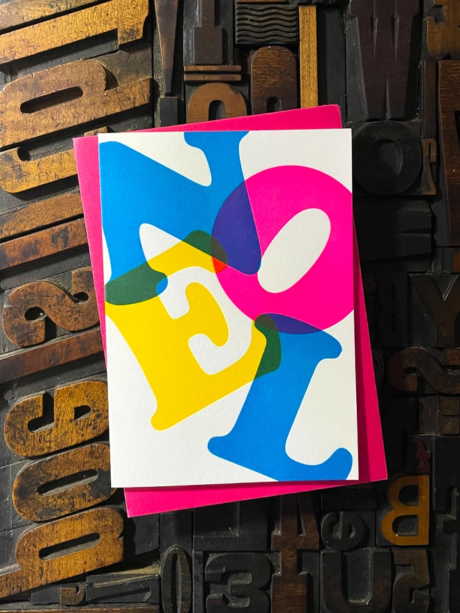 Noel, Joy, Hope; A beautiful typographic set of letterpress Christmas cards. Printed with rich vibrant and fluorescent blue, magenta and yellow inks with luxury matching and contrasting envelopes; ideal to send to your designer friends at the festive season.