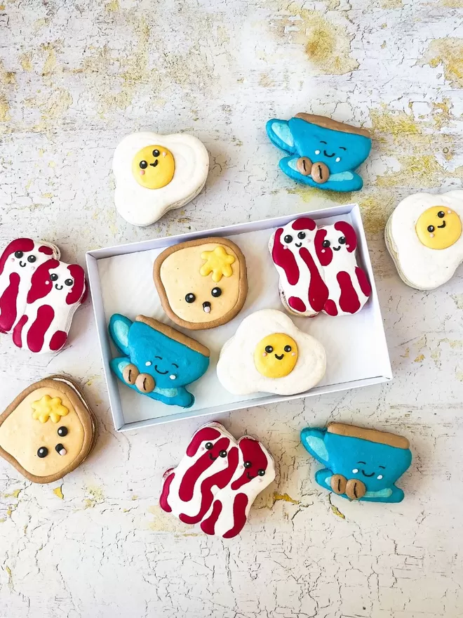 bacon, eggs, toast & coffee cup shaped giant macarons in a box on a table