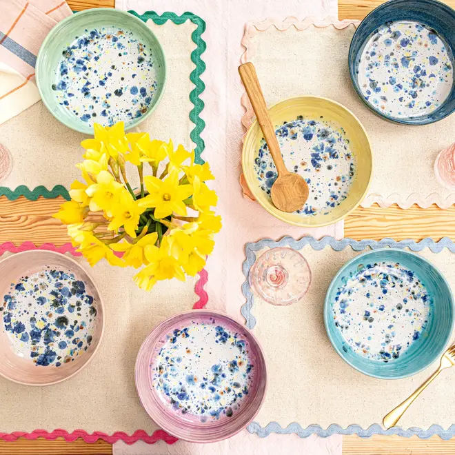 Shoreline Pasta Bowl, a colourful table setting made by bowls, napkins and cutlery. 