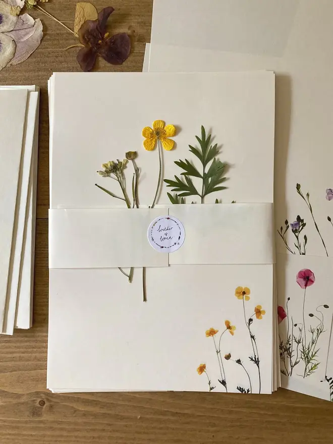 Pressed Wildflower Letter Writing Set, a pressed flower writing set sitting on a wooden surface. 