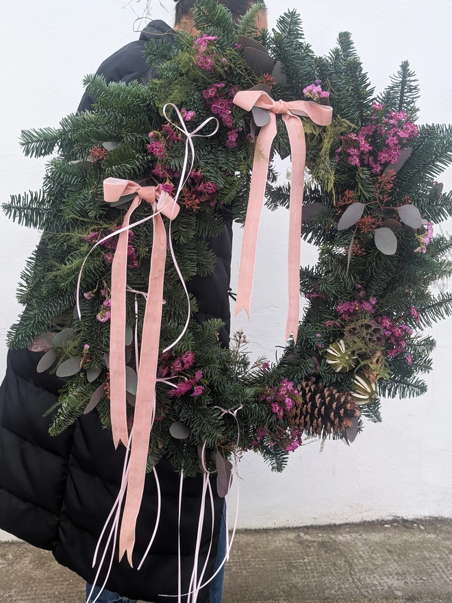 Large 20-inch handmade Christmas wreath on a wire frame, decorated with natural moss and foliage, ready for festive home décor.