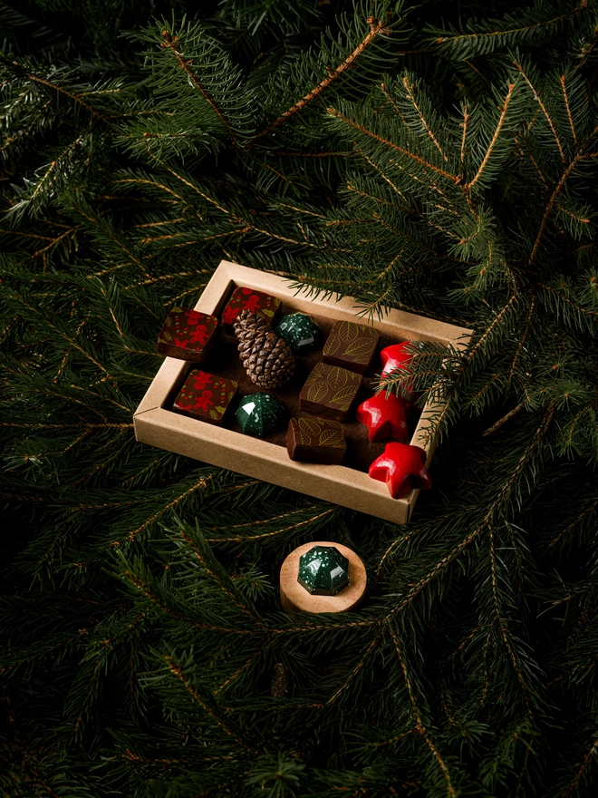 Christmas chocolate box open, showing 12 pieces of colourful festive bonbons