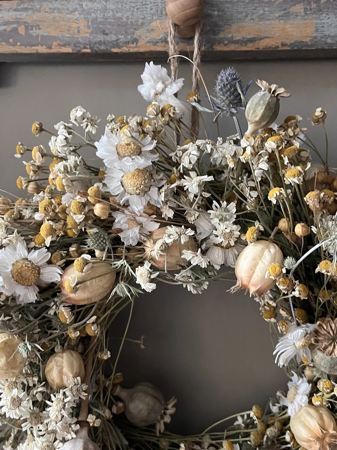 Autumnal Wreath. A wreath made of dried autumnal flowers, hung on a wall.