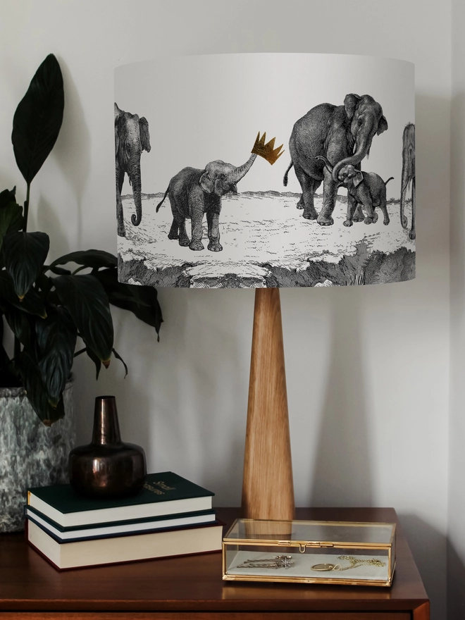 Handmade lampshade featuring adorable mischievous baby elephants playing together, inspired by Whipsnade Zoo, with a playful animal design.