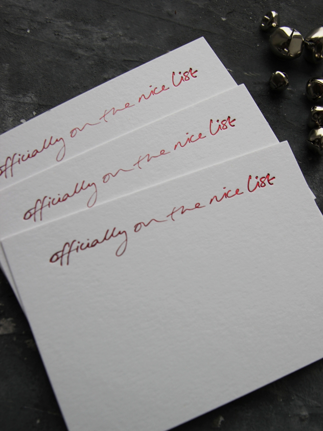 christmas notecard form Santa that says Officially On The Nice List in red foil with an envelope that says North Pole Mail